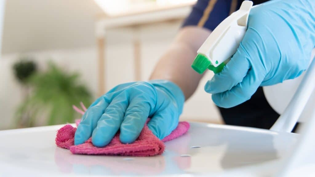 Residential cleaning team disinfecting kitchen counters homes.